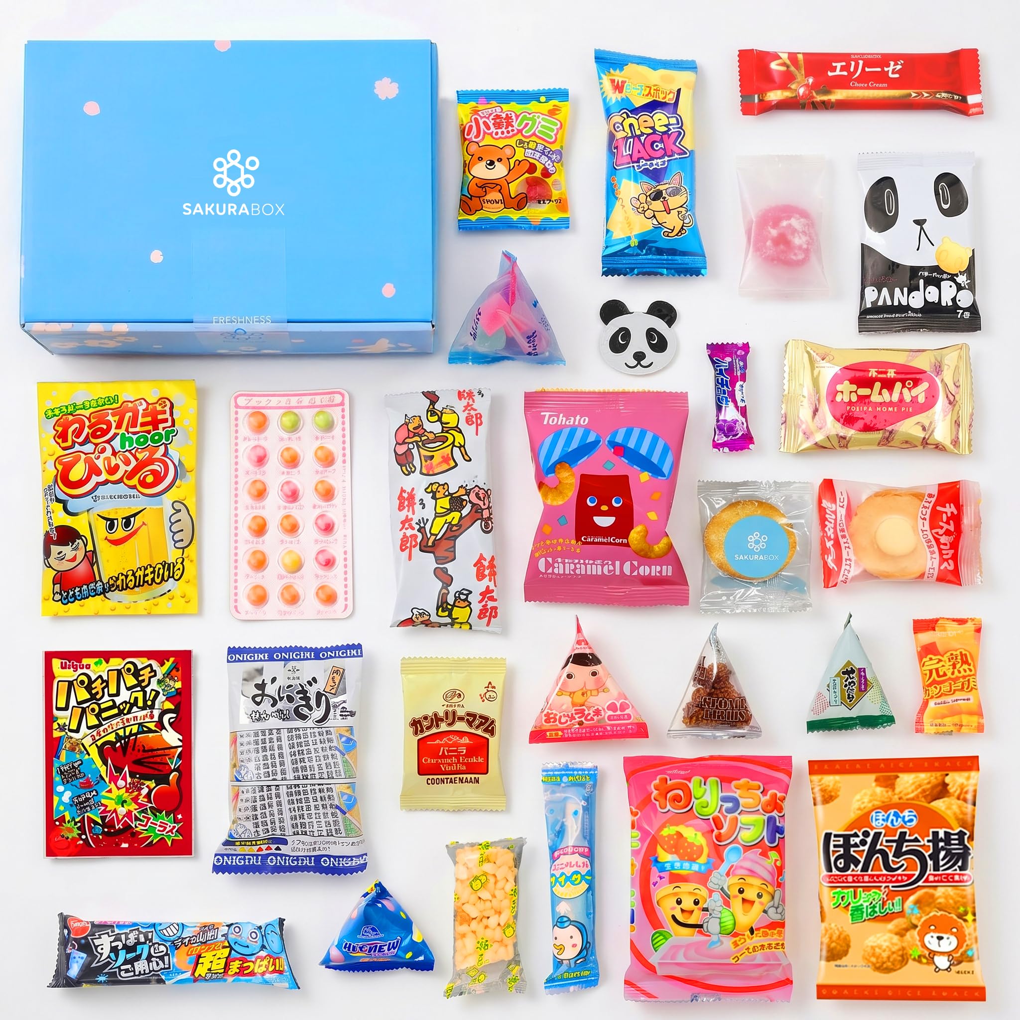 Thirty Japanese snacks arranged with one blue Sakura Box