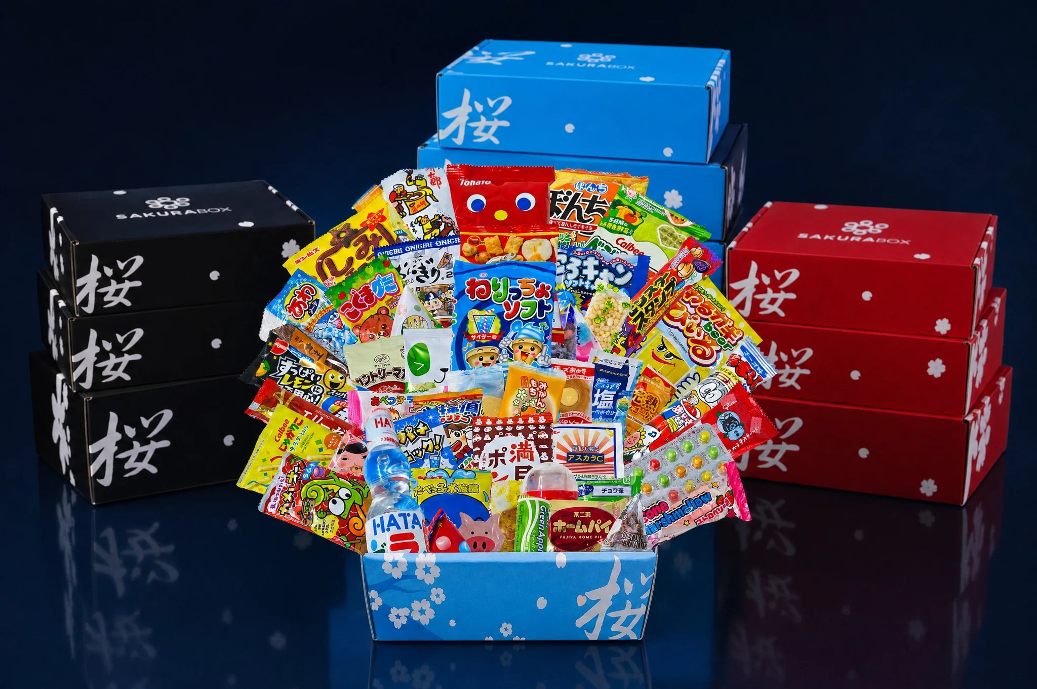 Sakura Box corporate gift boxes surrounding an open Japanese snack assortment